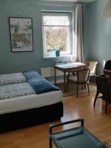 a bedroom with a bed and a desk and a table at Gutshaus Dämelow tussen Schwerin en Wismar in Dämelow