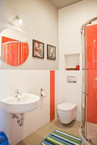 a bathroom with a sink and a toilet and a mirror at Pepe Hostel in Warsaw