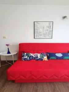 a red couch with pillows on it in a room at Apartment Lucia in Omišalj