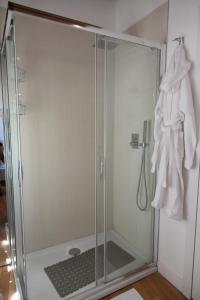 a shower stall with a glass door in a bathroom at Le Maree Deluxe Apartment by Dimore Trinacria in Siracusa +40 photos
