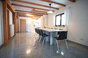 a large kitchen with a table and chairs at ANDRISS - Travel & Work - 5 BR - Kitchen - Parking in Kaiserslautern