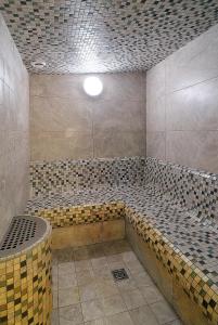a large bathroom with a tub and a shower at Hotel Visegrád in Visegrád