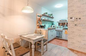 a kitchen with a table and a table and chairs at Sunset Resort 311 in Fonyód