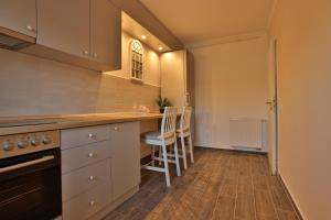 a kitchen with a counter and a table and chairs at Ada Homes B46 in Braşov