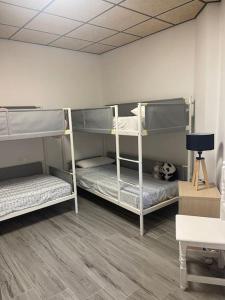 a room with three bunk beds in a room at Casita coqueta en Agua Amarga in Agua Amarga