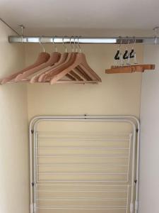 a closet with a white door and a rack with hangers at Appartement avec vue exceptionnelle sur Biarritz in Biarritz