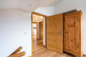 a room with a wooden door and a hallway at Wohnung am See in Gmund am Tegernsee