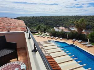 a view of a swimming pool on a balcony at Hotel Sa Barrera - Adults Only in Cala'n Porter