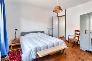 a bedroom with a bed and a table and a chair at Jolie maison pour 6 a Noirmoutier-en-l Ile in Noirmoutier-en-l'lle