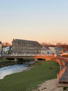 a bridge over a river with a building at Joli Studio proche Mer et Digue de Wimereux in Wimereux