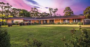 a house with a large lawn in front of it at Burncroft Guesthouse in Lovedale