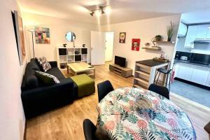 a living room with a couch and a table at Chez Sandra et Rach in Toulouse