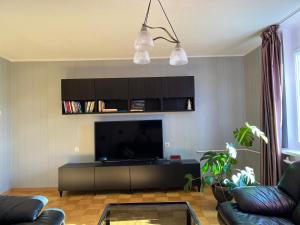a living room with a flat screen tv and a couch at Lahe korter in Haapsalu