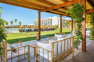 a patio at the resort with a view of the park at AP Cabanas Beach & Nature - Adults Friendly in Cabanas de Tavira