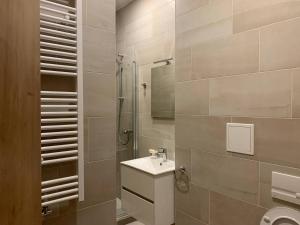 a bathroom with a sink and a shower at Brand new apartments and hostel in center in Prague