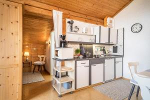 a kitchen with white cabinets and a counter top at Haus Sonnenhang Wohnung 3 in Stiefenhofen