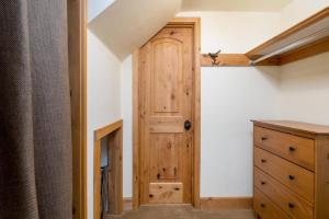 a room with a wooden door and a dresser at Krystal Villa #5 in Ketchum