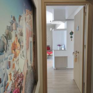 a hallway with a wall of pictures on the wall at Depie Luxury Apartment in Pastida in Pastida