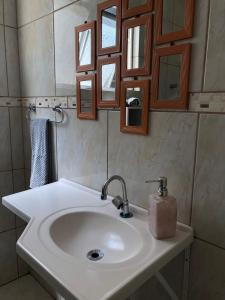 a bathroom with a sink and a mirror at excelente apartamento completo in Pelotas