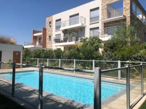 a swimming pool in front of a building at BLUE DREAM in Juan-les-Pins