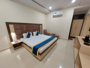 a bedroom with a large bed in a room at Hotel Vrinda in Maihar