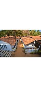 arial view of a row of houses with roofs at Baywatch Beach Resort patnem in Canacona