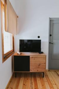 a flat screen tv sitting on top of a wooden dresser at Weź tu Przystań - Mikołajek 1 in Pomiechówek