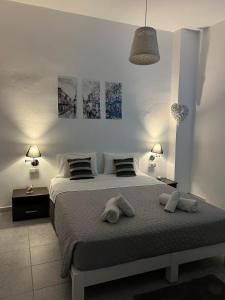 a bedroom with a bed with two pillows on it at Zolfo Antico Beach Apartment Perissa in Perissa