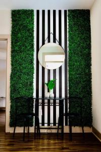 a table and chairs in a room with a green wall at Emerald City Luxury Suite ~Fully Gated Community in Midland