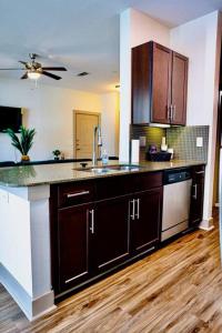 a kitchen with a sink and a counter top at Emerald City Luxury Suite ~Fully Gated Community in Midland