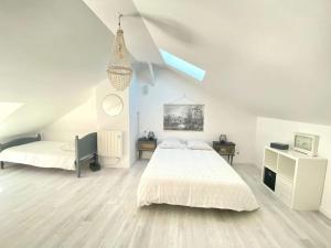 a white bedroom with a bed and a desk at l'Escapade Seysselane in Seyssel