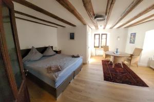 a bedroom with a bed and a table in it at Alter Posthof Lieser in Lieser