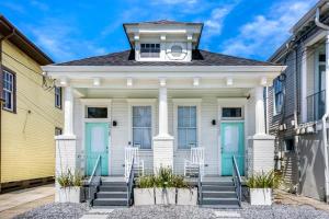 a white house with blue doors and stairs at Luxury 4BR in Uptown NOLA in New Orleans