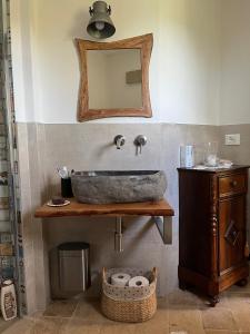 a bathroom with a stone sink and a mirror at Casa Sant Angelo in Pesaro