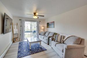 a living room with two couches and a table at Grand Junction Vacation Rental Indoor Pool Access in Grand Junction