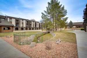 a apartment building with a garden in front of a building at Grand Junction Vacation Rental Indoor Pool Access in Grand Junction