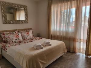 a bedroom with a bed with two towels on it at Rooms Sapina in Korenica