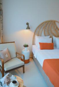 a bedroom with two beds and a chair and a table at Rijeka Alaçatı in Cesme