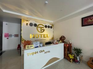a hotel lobby with a hotel sign on the wall at Thinh Gia Hotel in Bến Cát