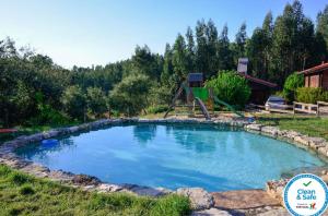 a large pool with a playground in a yard at Studio with shared pool enclosed garden and wifi at Figueiro dos Vinhos 6 km away from the beach in Figueiró dos Vinhos