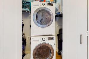 two washing machines and a washer and dryer in a room at Serene in Seattle in Seattle