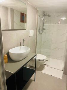a white bathroom with a sink and a shower at Corte San Gaetano in Bari +15 photos