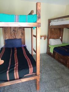 a room with two bunk beds in a house at Hostal The Friends in Panajachel