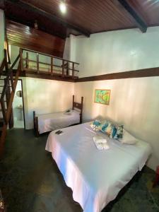 a bedroom with two beds and a loft at Solar da Praia Pousada in Arraial do Cabo +49 photos