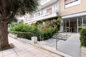 a building with a staircase in front of it at Flisvos Seafront-Marina apartment in Athens