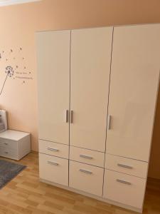 een grote witte kast in een kamer met een bed bij Noemi Appartman Szeged in Szeged