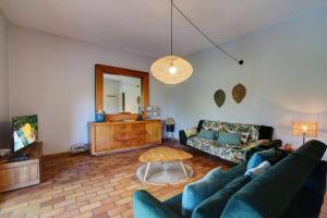 a living room with a couch and a table at Villa KazAlizés avec Piscine et Jardin Saint Leu in Saint-Leu