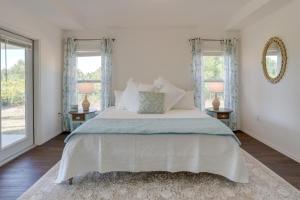 a bedroom with a large bed with two windows at Sunny Stays Vacation Rental in Southwest Florida! in Lehigh Acres
