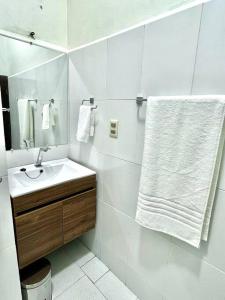 a white bathroom with a sink and a mirror at Departamento en La Paz, en pleno centro histórico in La Paz