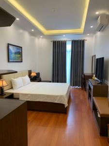 a hotel room with a bed and a television at Kim Tuyen Hotel in Ninh Binh